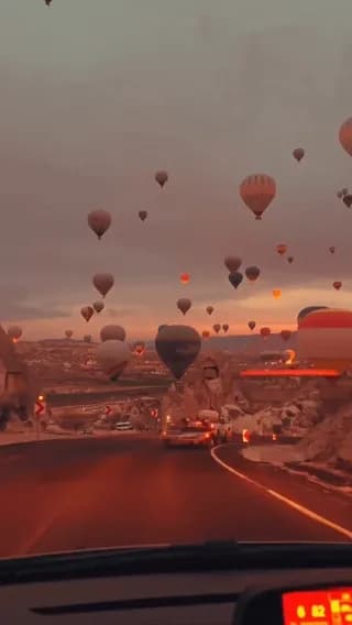 Hot air balloons depart at dawn over Cappadocia