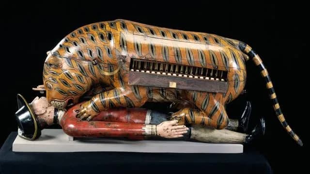 "Tipu's Tiger" - an 18th century custom made life sized toy depicting a tiger mauling a British soldier. It has 18 note pipe organ making the sound of a tiger, while simultaneously moving the soldiers