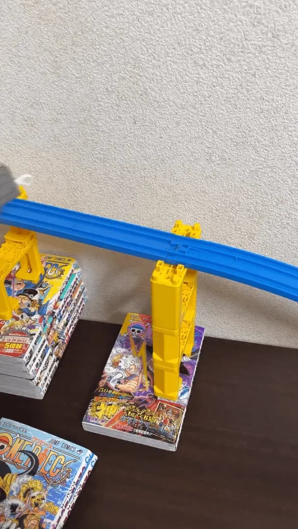 A complex Rube Goldberg machine feat. tracks, marbles, dominoes and more
