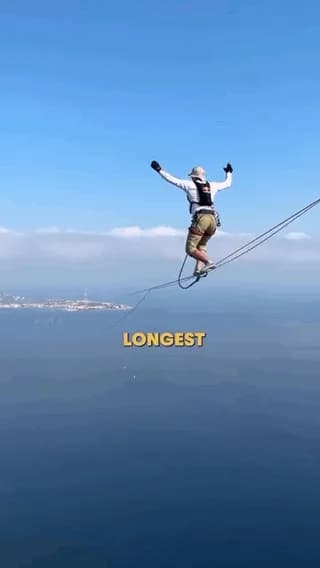Jaan Roose walking 3.6 km from mainland Italy to Sicily on a 1.9 cm wide slackline, around 100 metres above the sea. After nearly three hours, he fell just 80 metres before the finish, climbed back on