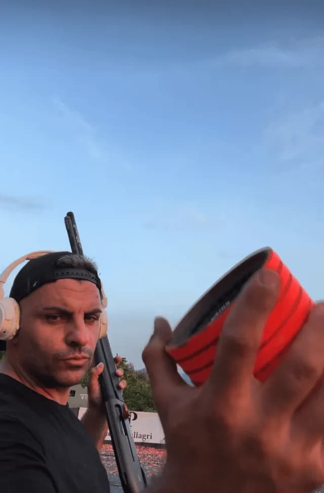 European Professional shooter champion Davide De Carolis throws multiple clay targets by hand before breaking them in rapid succession with a shotgun.