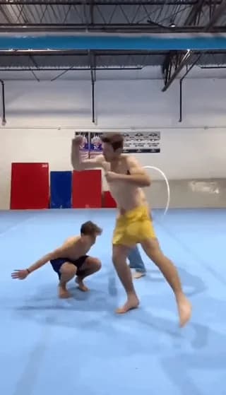 Three guys jumping through the same hoop