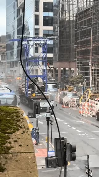 Apartment balcony view of practical stunt rigging and explosions being filmed for Spider-Man