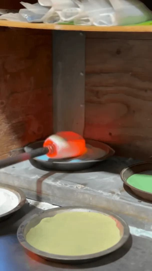Glassblower creating a Rainbow Trout decorative sculpture