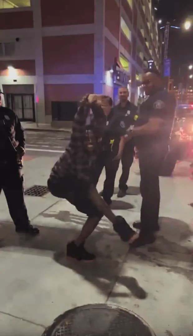 Extremely flexible guy doing a little show for the cops.