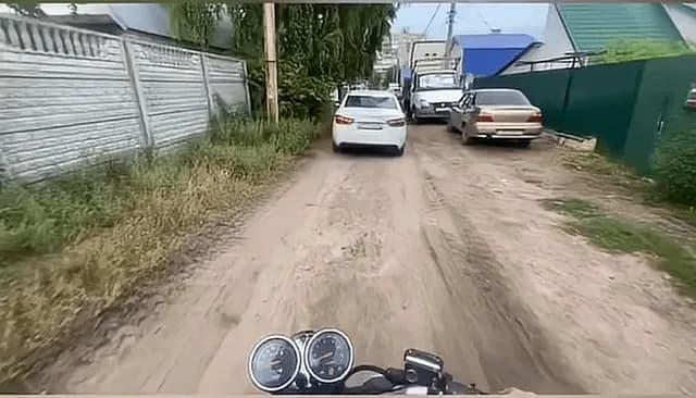 The dog was chasing the biker… until the pothole entered the chat