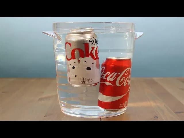 Regular Coca Cola sinks while diet floats due to the artificial sweetener being less dense