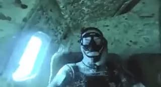 This man sitting in a sunken plane