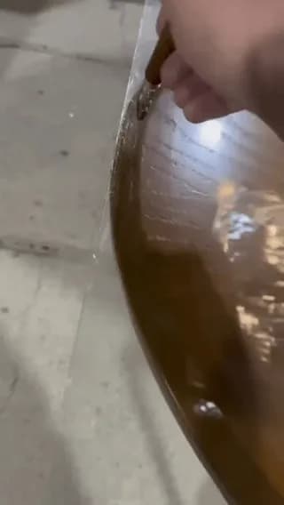 Manually cutting glass to match a curved wooden tabletop