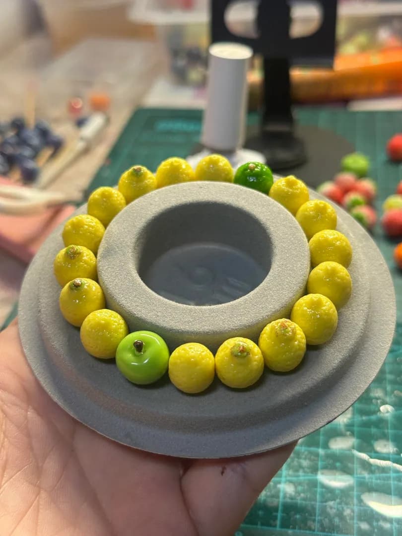 Handcrafted a bracelet made of tiny, realistic lemons/oranges out of polymer clay
