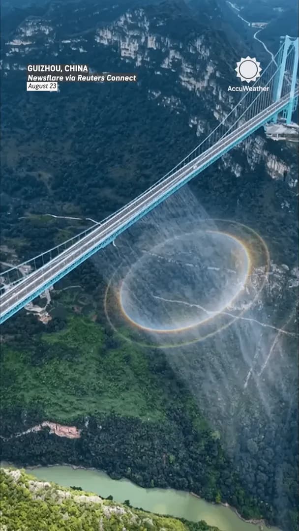 A full-circle rainbow appeared beneath the worldâs highest bridge as sunlight interacted with mist from water cascading below the massive structure during a water curtain show