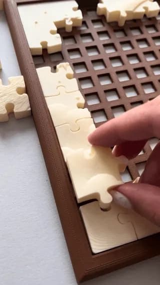 The click and snap of assembling this 3D-printed sleeping cat puzzle