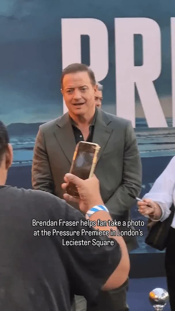 Brendan Fraser patiently helps a fan trying to take a photo with him