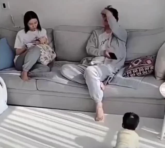 Parents watching their kid take his first steps