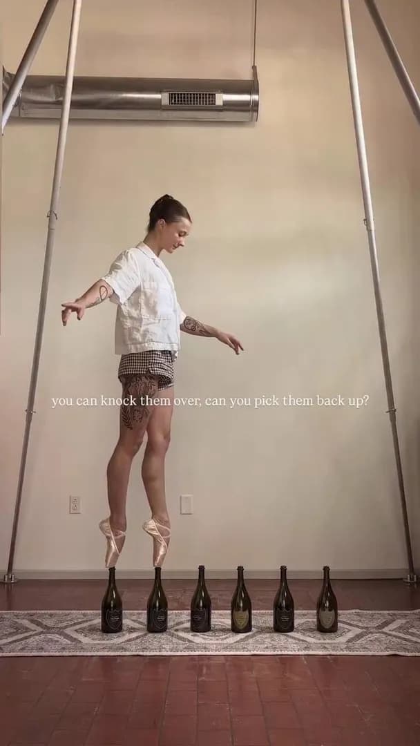 Walking on bottles en pointe wasn't enough, so she picked them up too!!