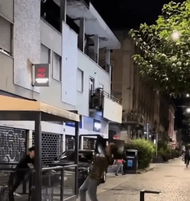 Barman disarmed person with knife through chairs and tables