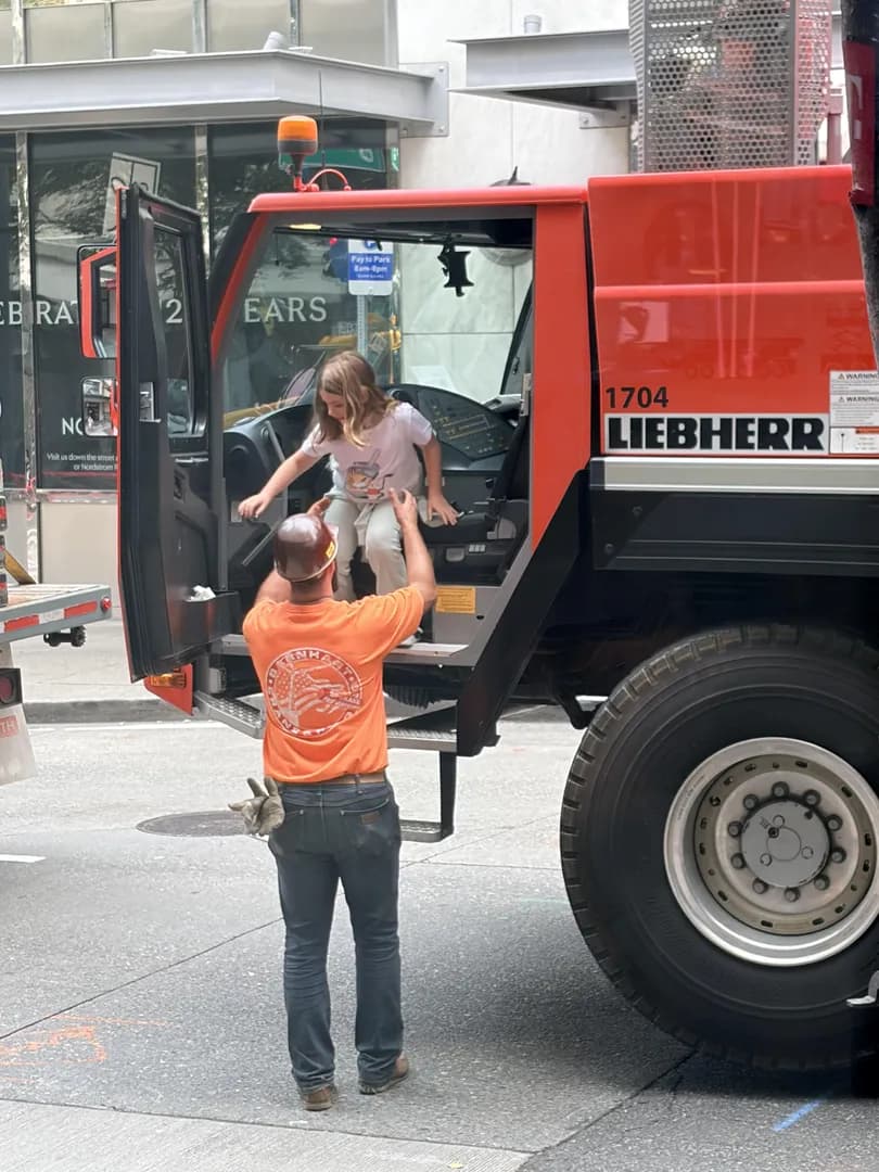 Construction worker lets random girl into the truck for an awesome childhood memory.