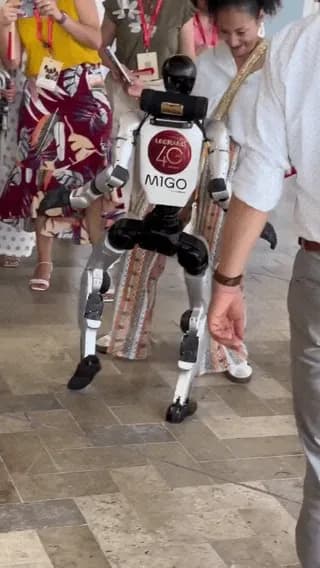 A humanoid robot shows a woman its moves in Cartagena, Colombia.