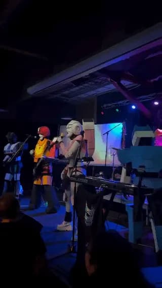 Full-costume Autobots performing live music and honoring Peter Cullen with crowd-surfing