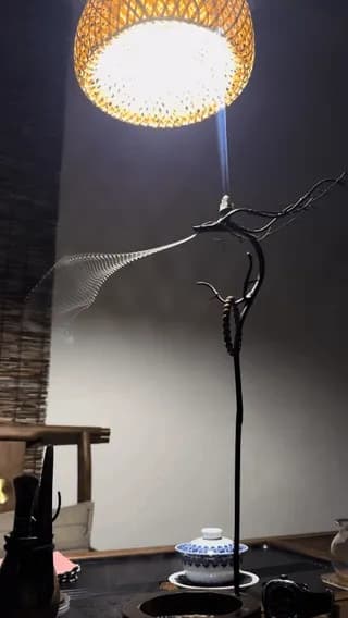 incense smoke flows like a liquid ribbon flowing through the air