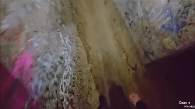 Man goes in (Paris Catacombs) guide leads him to secret location ( warning lots of bones)