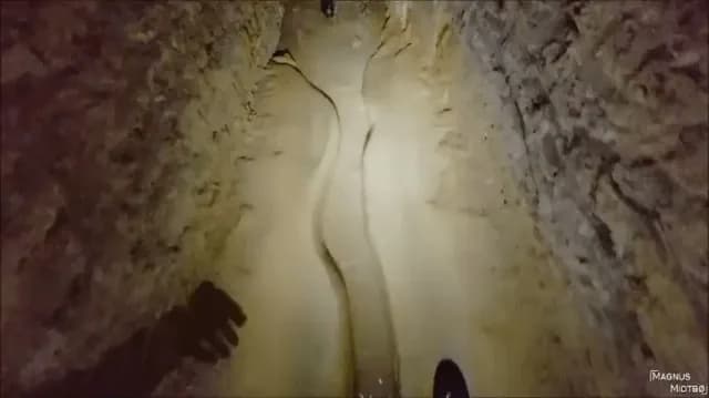 Man goes in (Paris Catacombs) guide leads him to secret location (warning lots of bones)