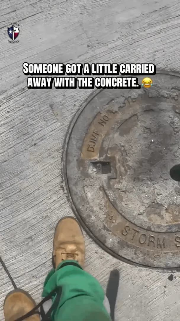 Sandblasting dried concrete from a manhole cover