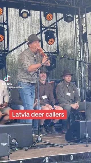 Professional Latvian deer callers competing on stage