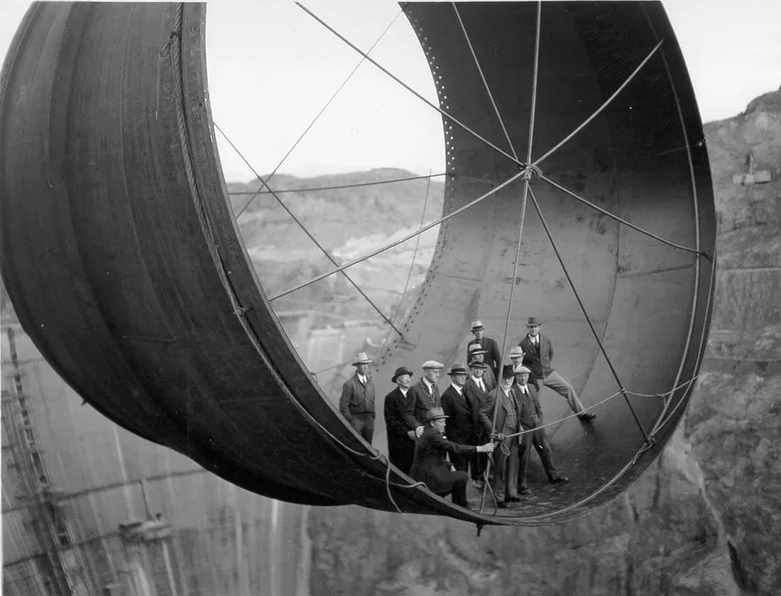 Photo of officials inside the one of the gigantic penstock pipes used in the Hoover dam, 1935.