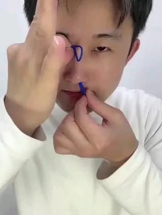 How to do the Rubber Band through the Eye magic trick