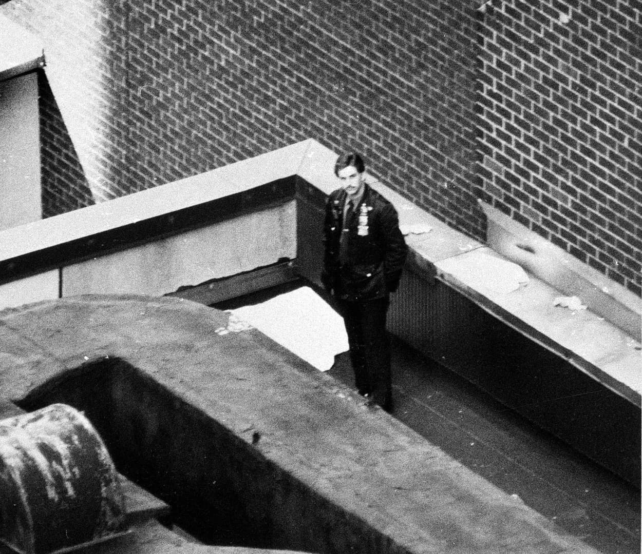 A New York City Police officer stands beside the covered body of 4 year old Conor Clapton, son of rock guitarist Eric Clapton. who fell from a 53rd-floor window to the roof of a four-story building We