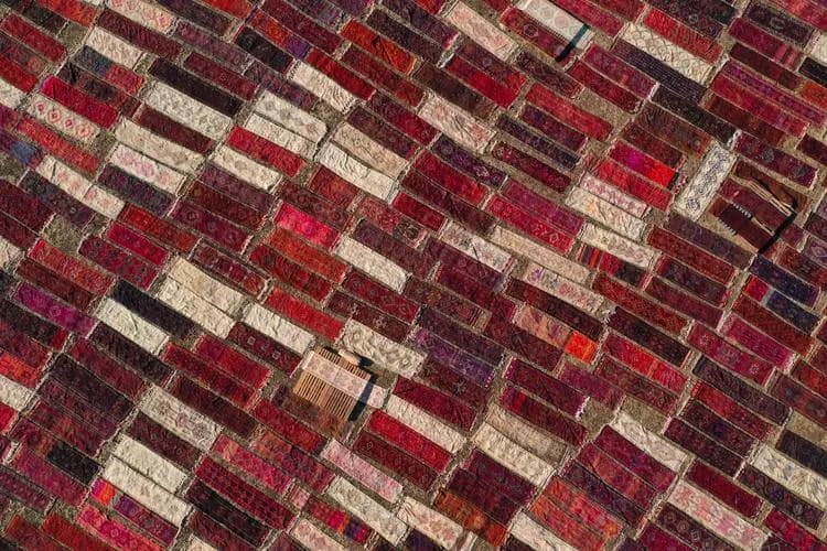 Thousands of handmade carpets are laid out across massive open-air fields in Döşemealtı, Türkiye every summer—baking under the sun until mid-October to naturally achieve vintage pastel tones and steri