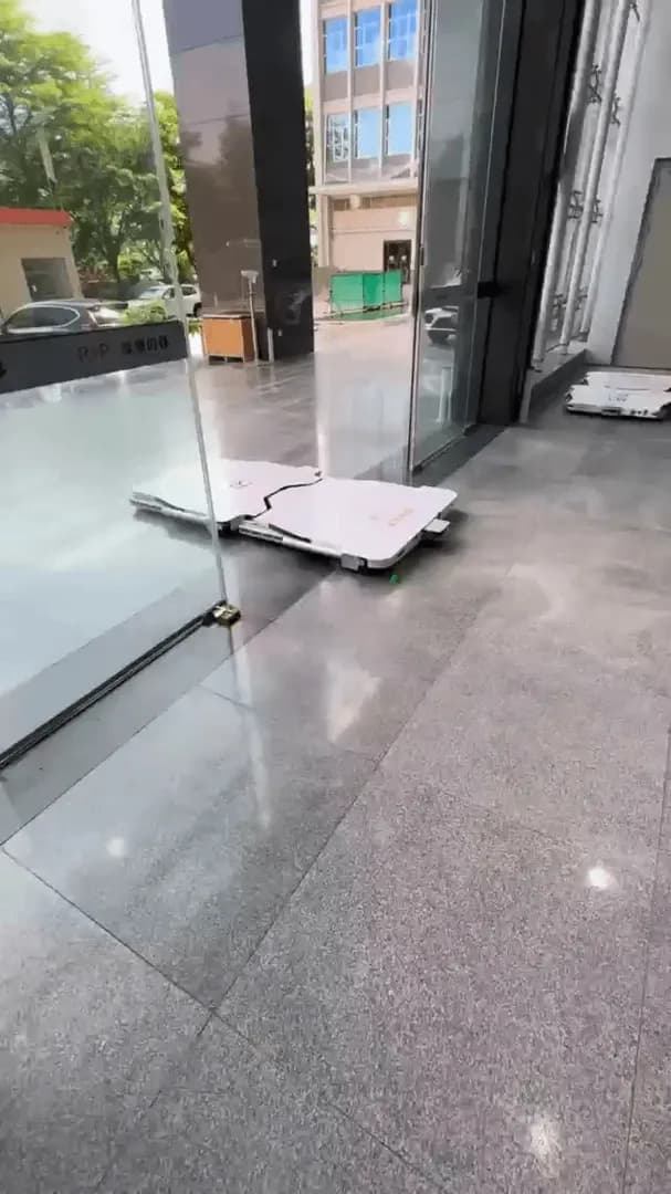 A robotic parking system that moves cars without a driver. Does anyone know the place or city this is from?