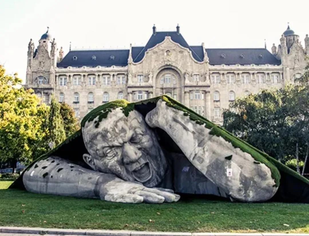 This giant sculpture in Budapest, Hungary, was made to look like a man tearing his way out of the ground.