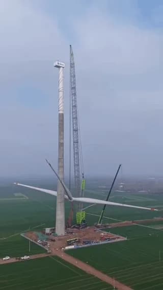 The sheer size of this wind turbine blade being hoisted into place by a crawler crane