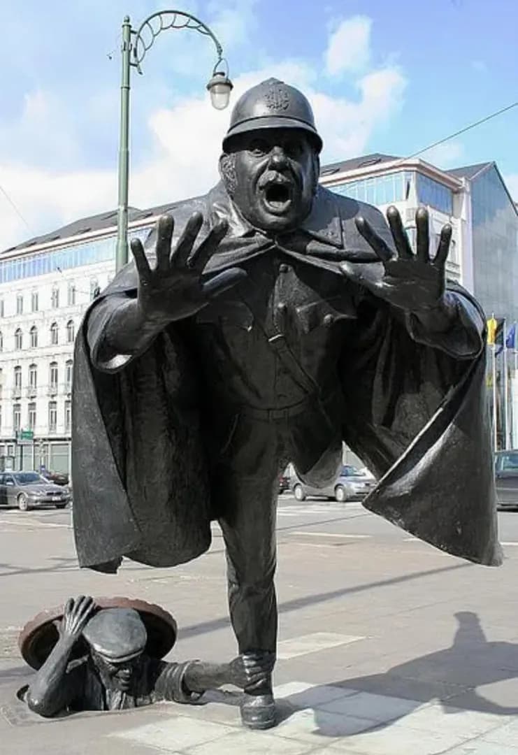 Brussels has a bronze sculpture of a man emerging from a manhole to trip a police officer.