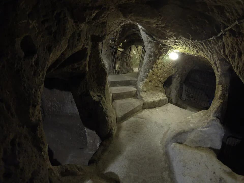 In 1963 , a Turkish man knocked down a basement wall during renovations and accidentally discovered Derinkuyu , an ancient underground city extending 18 stories deep , It was equipped with schools , c