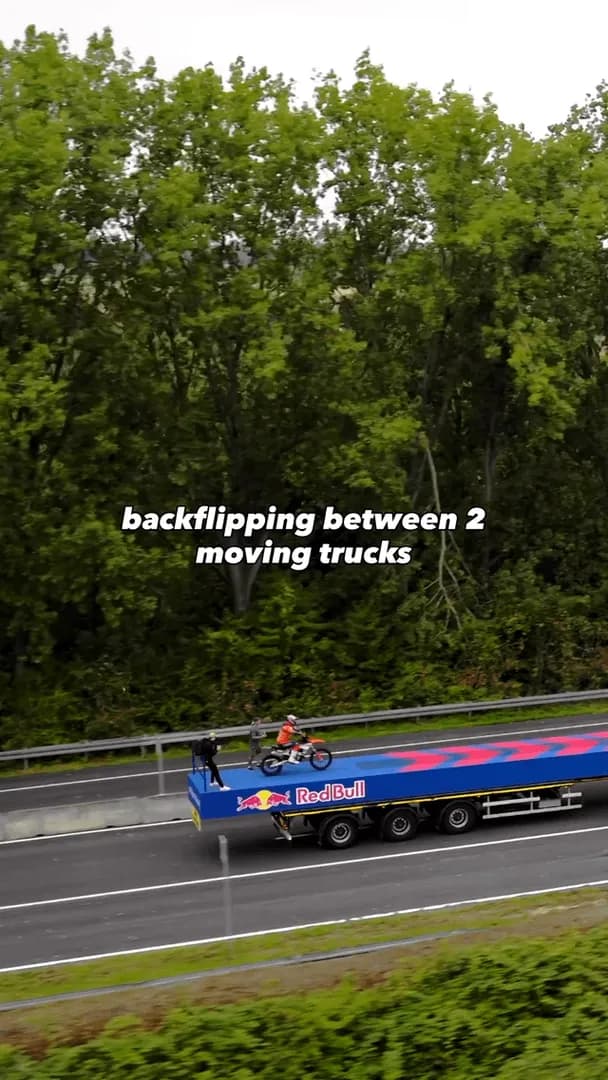 Backflipping between 2 moving trucks and over a highway sign