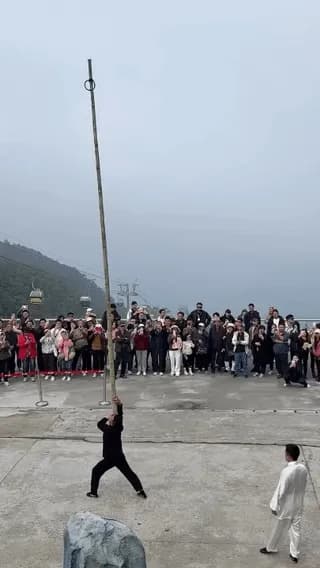 Balancing on bamboo on another person