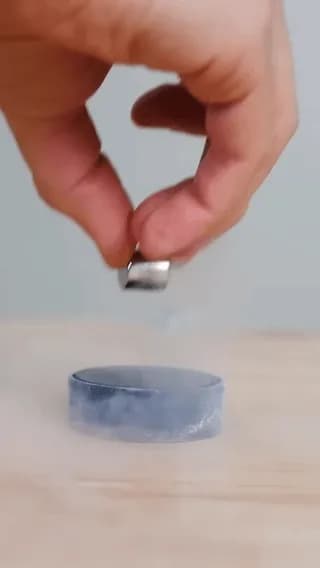 A Type II superconductor disc cooled with liquid nitrogen, demonstrating the physics phenomenon of quantum locking as it tracks along a magnetic pathway.