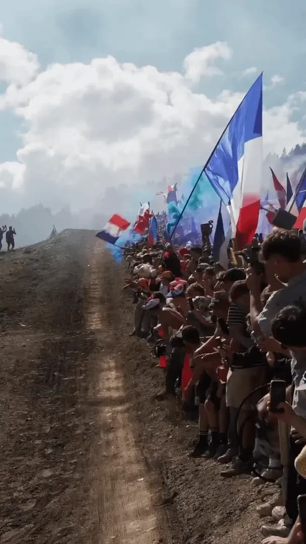 French infantry charging behind Max Alran winning the 2026 Downhill Mountain Bike World Cup
