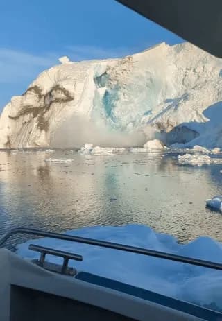 A block of ice breaking off from an iceberg creates a huge wave