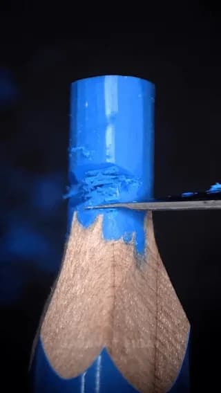 Carving a miniature rose out of colored pencil lead