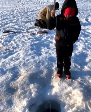 Kid catches a fish almost as big as him