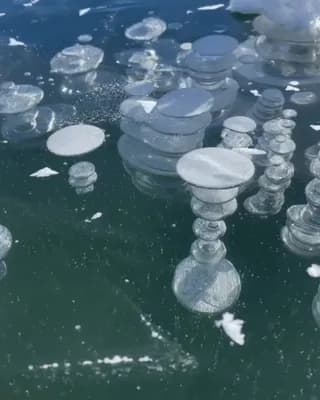 Frozen methane bubbles trapped beneath a Swiss lake create an otherworldly landscape.