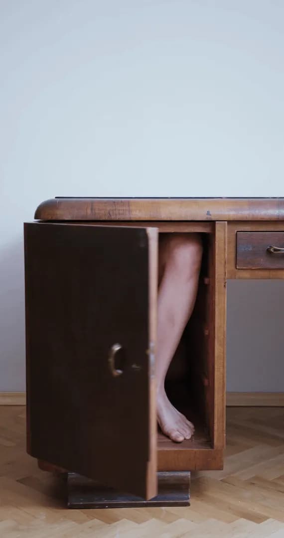 Contortionist folds herself into a wooden cabinet — this one is even more WTF visually because she's literally fitting her body into the furniture.