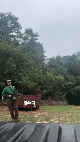 Unleashing the ultimate firepower with a .50 Cal and a massive drum mag setup.