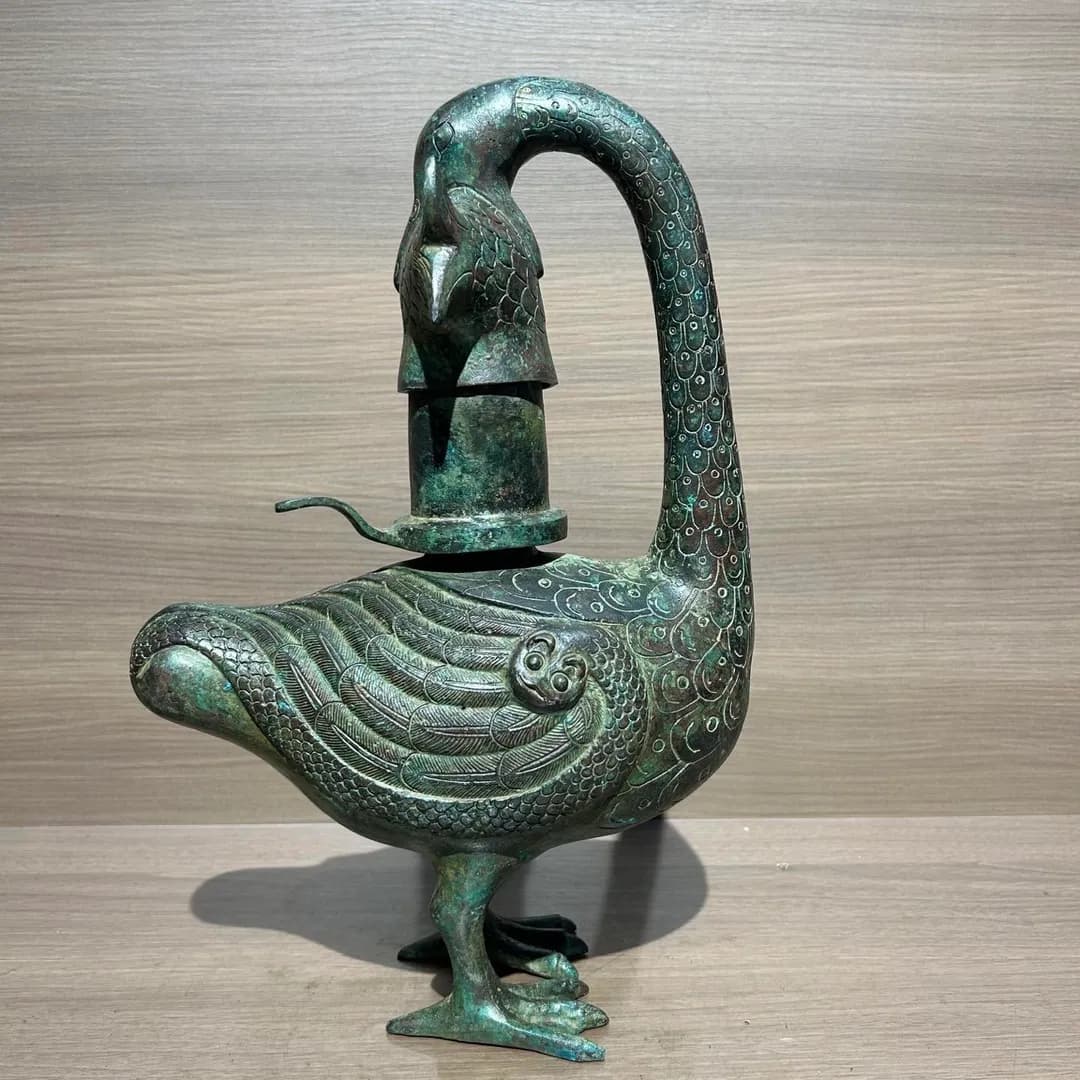 Ancient Chinese "smart lamp": A goose holding a fish, and it sucks up all lamp smoke into water.(The object shown is a reproduction; the original piece resides in the National Museum of China)