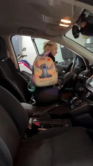 Para-athlete and mother Dejana Bačko driving her car completely using her feet.